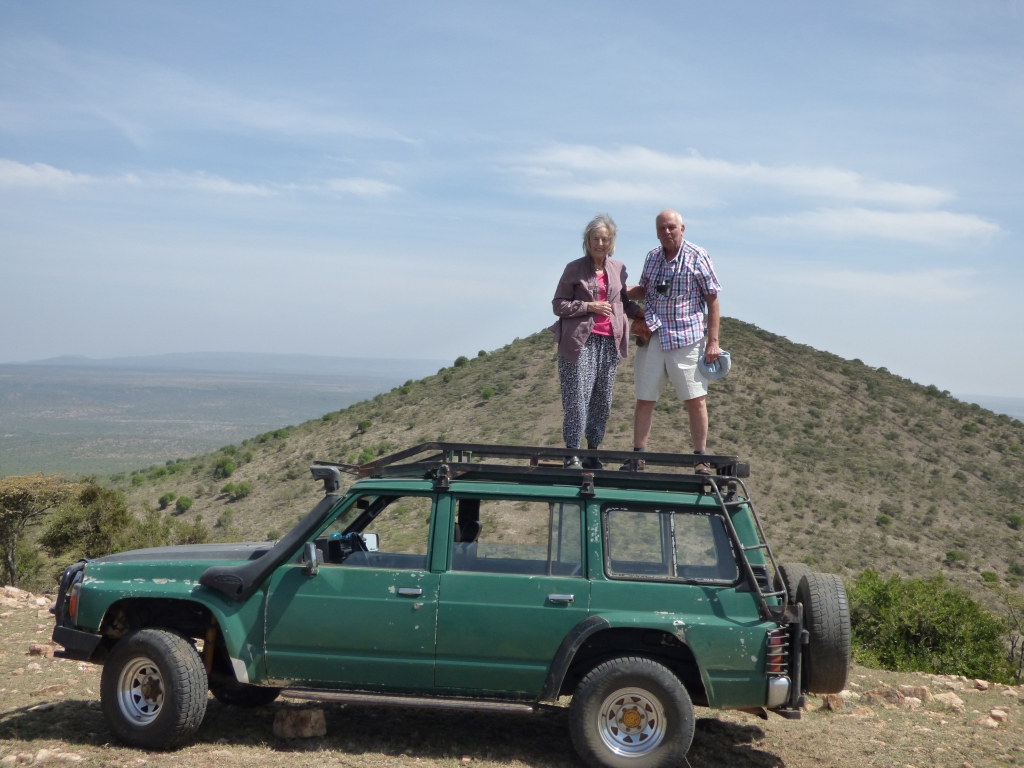 The Coopers survey the terrain from the top of their hosts' four-wheel drive vehicle